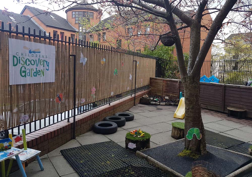Children playing outdoors in the nursery garden